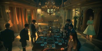 Movie still from “The Umbrella Academy” (2019), created by Steve Blackman – A group of people sitting around a dinner table; Wide shot, High angle