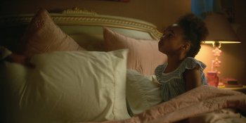 Movie still from “The Umbrella Academy” (2019), created by Steve Blackman – A little girl laying in a bed with pillows; Medium shot, High angle