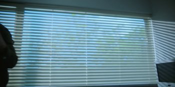 Movie still from “The Umbrella Academy” (2019), created by Steve Blackman – A view of a window with blinds open; Extreme Close Up shot, Low angle