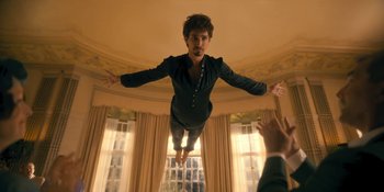 Movie still from “The Umbrella Academy” (2019), created by Steve Blackman – A man flying through the air with his arms outstretched; Medium shot, Low angle