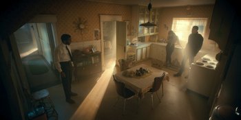 Movie still from “The Umbrella Academy” (2019), created by Steve Blackman – Two people are standing in a kitchen with a table and chairs; Extreme Wide shot, High angle