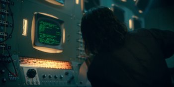 Movie still from “The Umbrella Academy” (2019), created by Steve Blackman – A person is looking at a computer screen; Medium shot, Over the shoulder angle