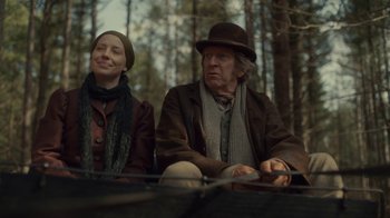 Movie still from “Anne with an E” (2017), created by Moira Walley-Beckett – A man and a woman sitting on a bench; Medium shot, Over the shoulder angle