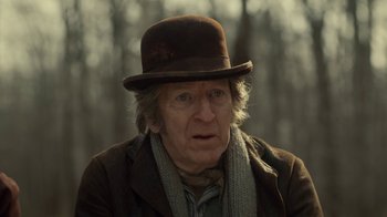 Movie still from “Anne with an E” (2017), created by Moira Walley-Beckett – An older man wearing a hat and a scarf; Close Up shot, Over the shoulder angle