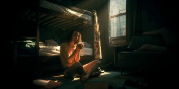 Movie still from “The Umbrella Academy” (2019), created by Steve Blackman – A man sitting on the ground in a room; Medium shot, Low angle