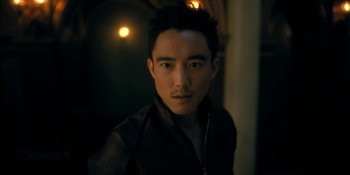 Movie still from “The Umbrella Academy” (2019), created by Steve Blackman – A young man with dark hair wearing a black jacket; Close Up shot, Over the shoulder angle
