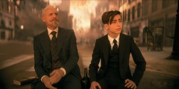 Movie still from “The Umbrella Academy” (2019), created by Steve Blackman – Two men in suits sitting next to each other; Medium shot, Over the shoulder angle