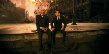 Movie still from “The Umbrella Academy” (2019), created by Steve Blackman – Two men in suits sitting next to each other on a ledge; Wide shot, High angle