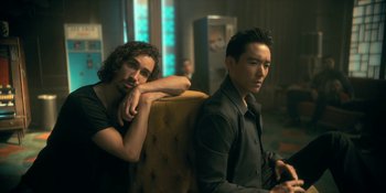 Movie still from “The Umbrella Academy” (2019), created by Steve Blackman – A couple of men sitting next to each other on a couch; Medium shot, Over the shoulder angle