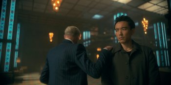 Movie still from “The Umbrella Academy” (2019), created by Steve Blackman – A man in a suit and a man in a black jacket; Medium shot, Over the shoulder angle