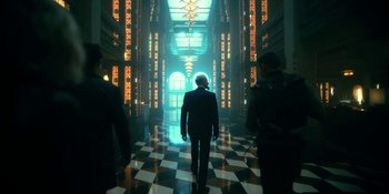 Movie still from “The Umbrella Academy” (2019), created by Steve Blackman – A man in a suit walking through a hall way; Wide shot, Low angle