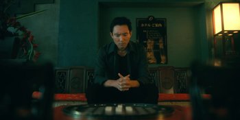 Movie still from “The Umbrella Academy” (2019), created by Steve Blackman – A man sitting in front of a piano keyboard; Medium shot, High angle