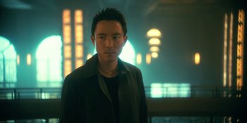 Movie still from “The Umbrella Academy” (2019), created by Steve Blackman – A man standing in front of a wall with lights in the background; Close Up shot, Low angle