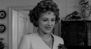 Movie still from “The Visit” (1964), directed by Bernhard Wicki – An old photo of an older woman with curly hair; Close Up shot, Low angle