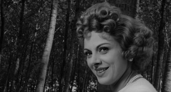 Movie still from “The Visit” (1964), directed by Bernhard Wicki – A black and white photo of a woman in a forest; Close Up shot, Low angle