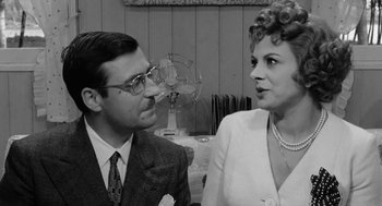 Movie still from “The Visit” (1964), directed by Bernhard Wicki – An older man and a younger woman are looking at one another; Medium shot, Over the shoulder angle