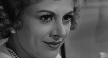 Movie still from “The Visit” (1964), directed by Bernhard Wicki – A woman's eyes and face in black - and - white; Close Up shot, High angle