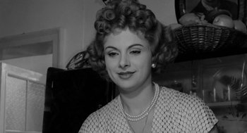 Movie still from “The Visit” (1964), directed by Bernhard Wicki – An old photo of an older woman with curly hair; Close Up shot, Low angle