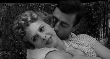 Movie still from “The Visit” (1964), directed by Bernhard Wicki – A man and a woman are kissing in a black - and - white photo; Close Up shot, High angle