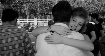 Movie still from “The Visit” (1964), directed by Bernhard Wicki – A man and a woman hugging each other outside; Medium shot, Over the shoulder angle