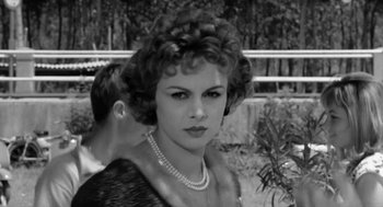 Movie still from “The Visit” (1964), directed by Bernhard Wicki – An old photo of a woman with a necklace; Close Up shot, Over the shoulder angle