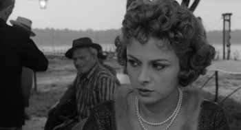 Movie still from “The Visit” (1964), directed by Bernhard Wicki – An older man and a young woman sitting next to each other; Close Up shot, Over the shoulder angle
