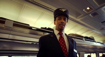 Movie still from “The Visit” (2015), directed by M. Night Shyamalan – A man in a suit and tie wearing a hat and tie; Medium shot, Low angle