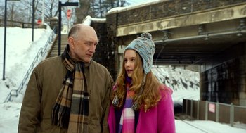 Movie still from “The Visit” (2015), directed by M. Night Shyamalan – A man standing next to a woman wearing a hat; Medium shot, Over the shoulder angle