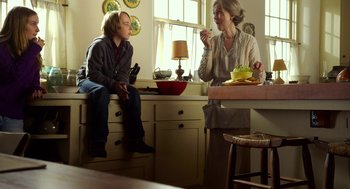 Movie still from “The Visit” (2015), directed by M. Night Shyamalan – A woman and a boy sitting in a kitchen; Medium shot, Over the shoulder angle