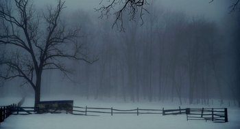 Movie still from “The Visit” (2015), directed by M. Night Shyamalan – A fence in the middle of a snowy field; Extreme Wide shot, High angle