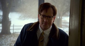 Movie still from “The Visit” (2015), directed by M. Night Shyamalan – A person wearing glasses and a tie; Close Up shot, Over the shoulder angle