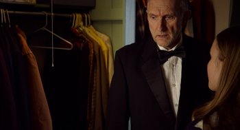 Movie still from “The Visit” (2015), directed by M. Night Shyamalan – An older man wearing a tuxedo in front of a closet; Close Up shot, Low angle