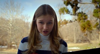 Movie still from “The Visit” (2015), directed by M. Night Shyamalan – A young girl with long blonde hair wearing a striped sweater; Close Up shot, Low angle