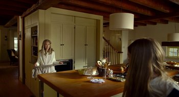 Movie still from “The Visit” (2015), directed by M. Night Shyamalan – A woman standing in front of a kitchen counter; Medium shot, Over the shoulder angle
