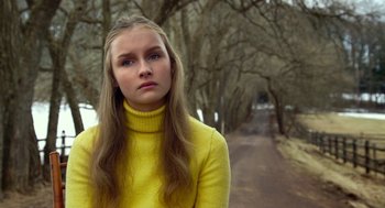 Movie still from “The Visit” (2015), directed by M. Night Shyamalan – A woman in a yellow sweater standing on the side of a road; Close Up shot, Low angle
