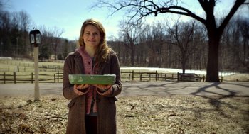 Movie still from “The Visit” (2015), directed by M. Night Shyamalan – A woman holding a box in her hands; Medium shot, Low angle