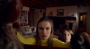 Movie still from “The Visit” (2015), directed by M. Night Shyamalan – Two young girls in a living room looking into a mirror; Medium shot, Low angle