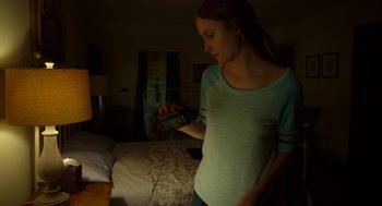 Movie still from “The Visit” (2015), directed by M. Night Shyamalan – A woman holding a cell phone in her hand; Medium shot, Low angle