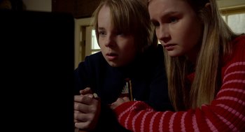 Movie still from “The Visit” (2015), directed by M. Night Shyamalan – Two young people looking at a computer screen; Close Up shot, High angle