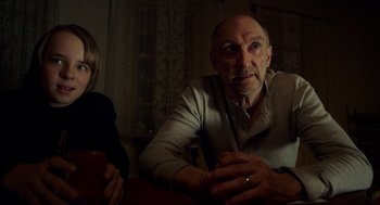 Movie still from “The Visit” (2015), directed by M. Night Shyamalan – An older man sitting next to a young boy; Close Up shot, Over the shoulder angle