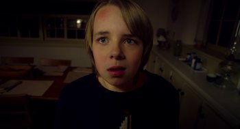 Movie still from “The Visit” (2015), directed by M. Night Shyamalan – A young boy is looking at the camera; Close Up shot, Low angle