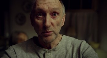 Movie still from “The Visit” (2015), directed by M. Night Shyamalan – An older man with a bald head and a mustache; Close Up shot, Low angle