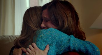 Movie still from “The Visit” (2015), directed by M. Night Shyamalan – Two women hugging each other in a living room; Close Up shot, Over the shoulder angle