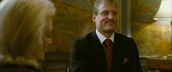 Movie still from “The Walker” (2007), directed by Paul Schrader – A man wearing a suit and tie smiling; Close Up shot, Low angle