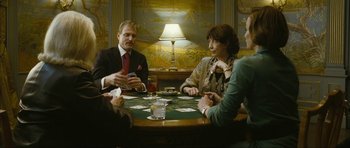 Movie still from “The Walker” (2007), directed by Paul Schrader – A group of people sitting at a table with cards; Medium shot, Over the shoulder angle