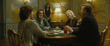 Movie still from “The Walker” (2007), directed by Paul Schrader – A group of people sitting at a table playing cards; Medium shot, High angle