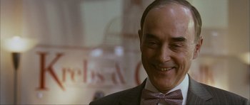 Movie still from “The Walker” (2007), directed by Paul Schrader – An older man wearing a suit and a bow tie; Close Up shot, Over the shoulder angle