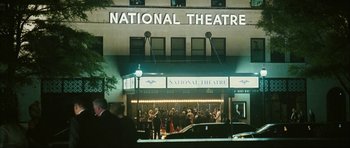 Movie still from “The Walker” (2007), directed by Paul Schrader – People are standing outside of a national theatre; Extreme Wide shot, Low angle