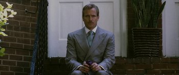 Movie still from “The Walker” (2007), directed by Paul Schrader – A man in a suit and tie holding a cell phone; Medium shot, Low angle