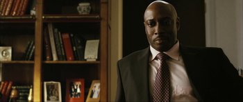 Movie still from “The Walker” (2007), directed by Paul Schrader – A man wearing a suit and tie in a room; Close Up shot, Low angle